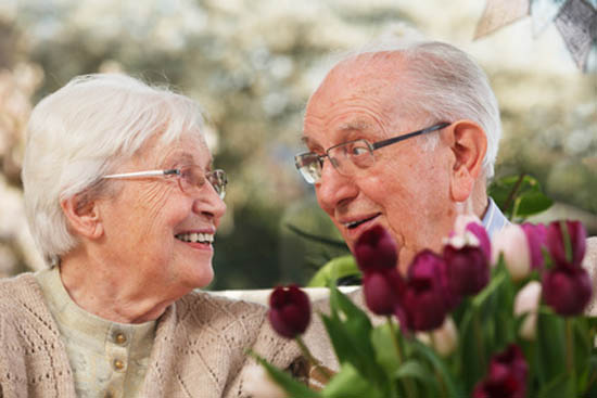 elderly couple with a bunch of tulips